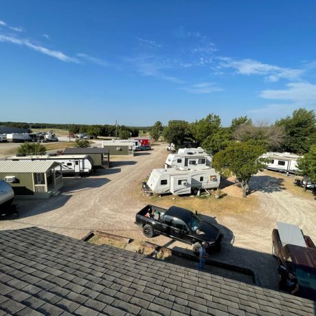 aerial view on a nice day where you can see the property and vehicles